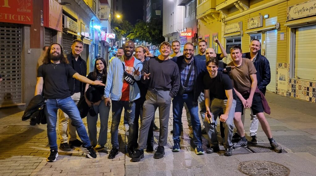 Group of travelers on Las Palmas Pub Crawl at night, Santa Catalina area